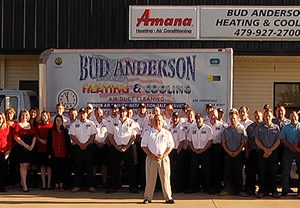 Bud Anderson staff in from of their building with a van in the background