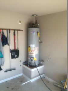 Gray water heater in the corner of a house.